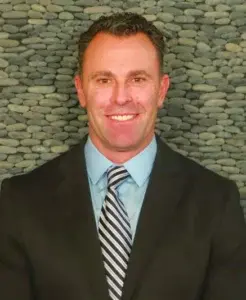 Dr. Kevin Sambuchino in professional attire smiling as a leading dentist in Erie at State Street Dental